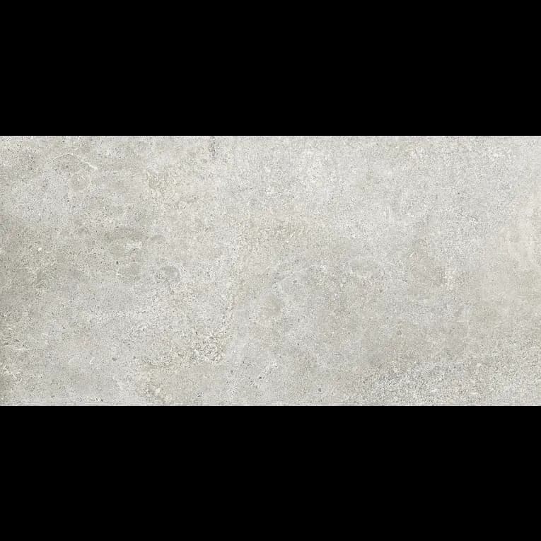 A white stone wall with some type of substance on it