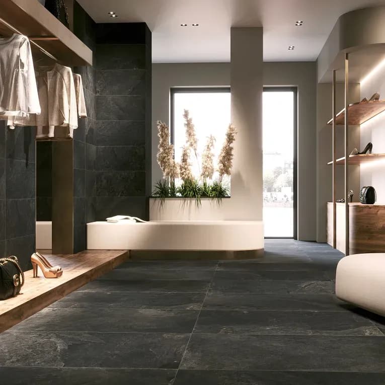 A room with a large black tile floor.