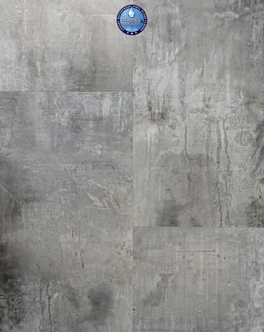 A gray concrete wall with some black spots on it