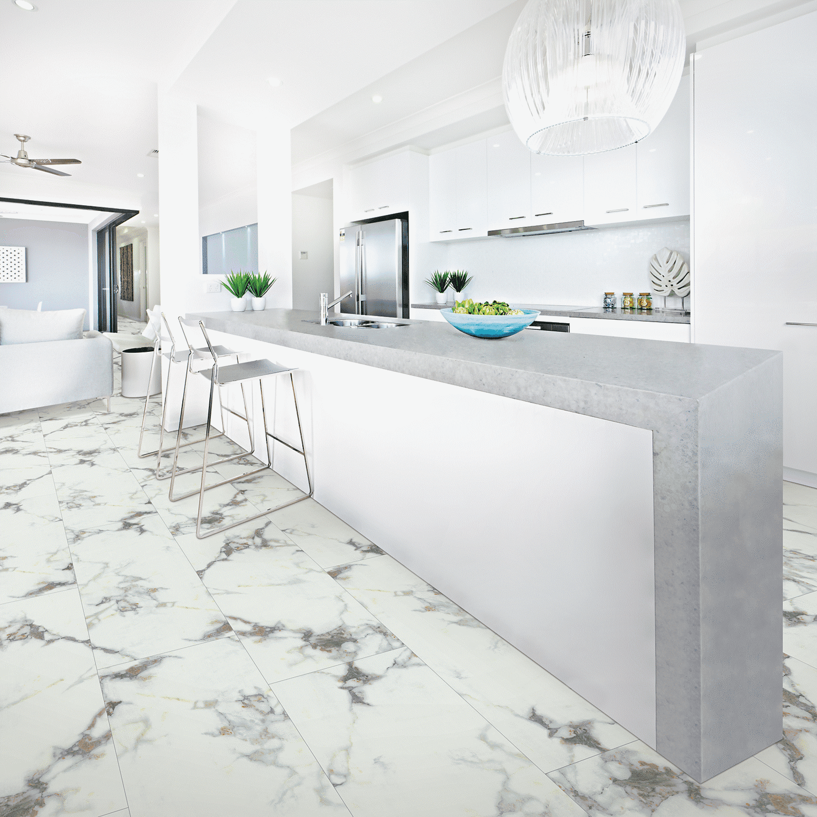 A white kitchen with marble floors and counters.