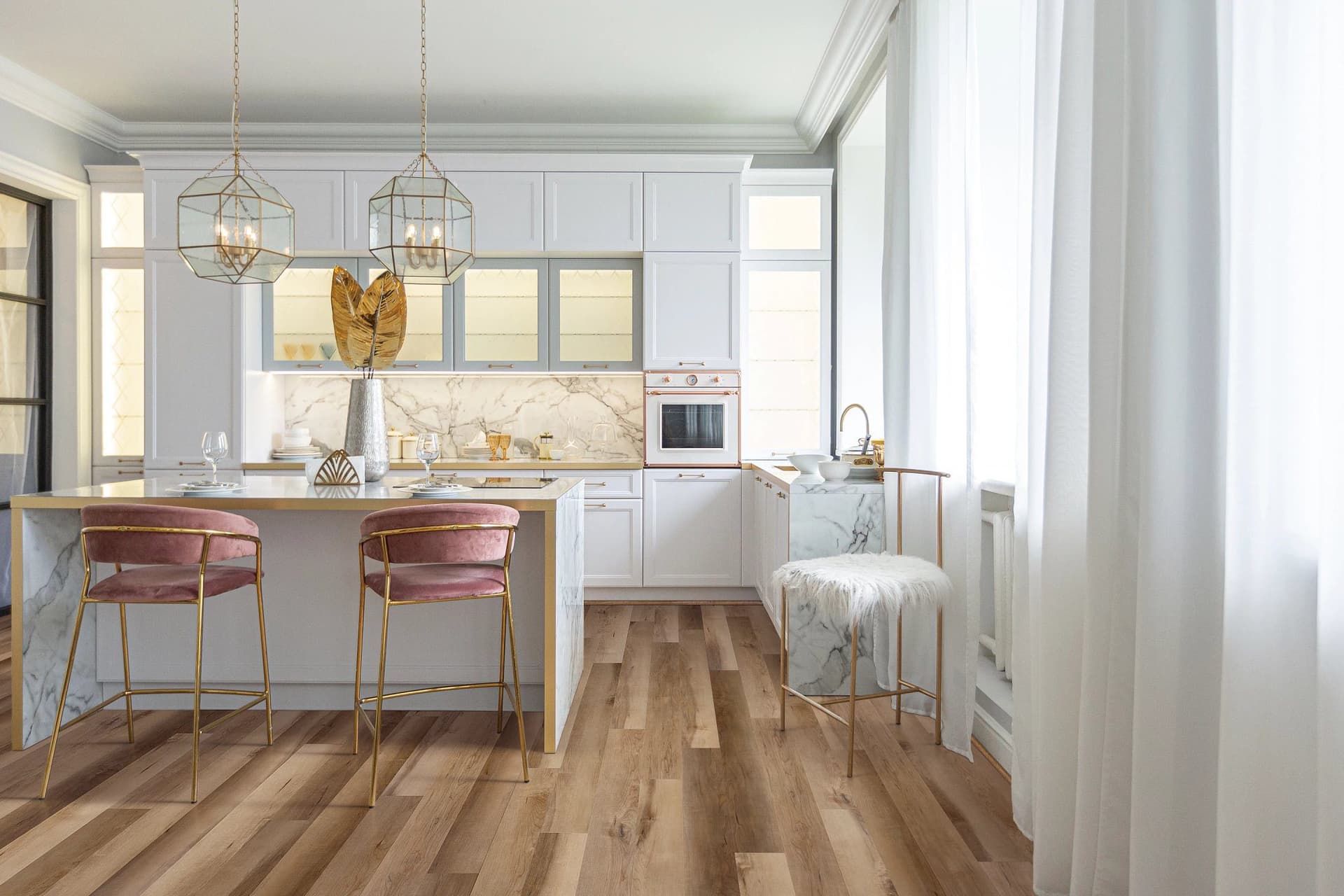 A kitchen with white cabinets and wooden floors.