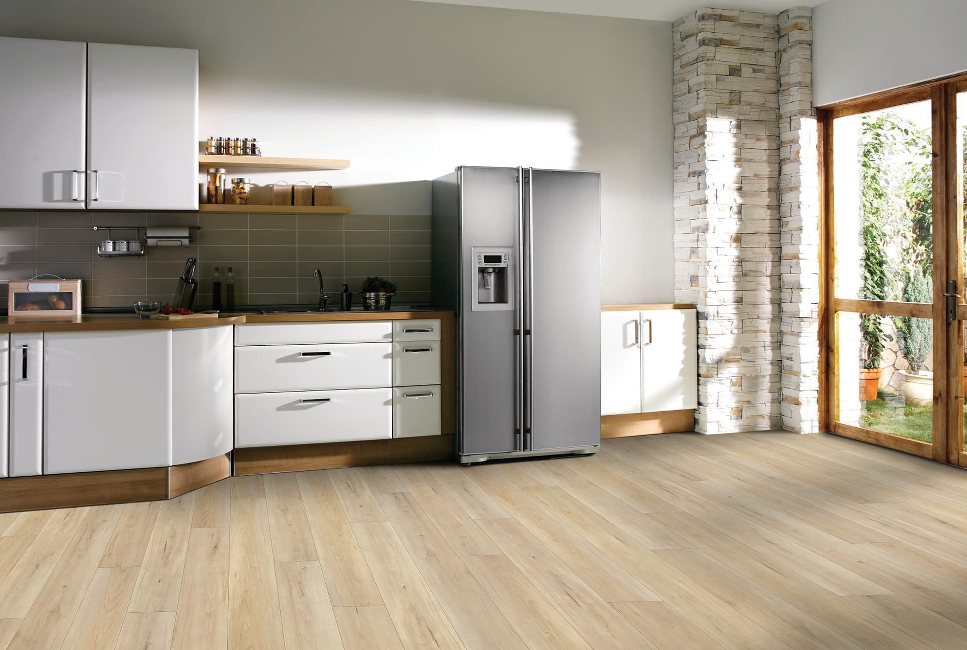 A kitchen with white walls and wooden floors.