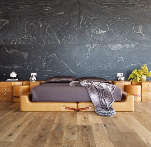 A bed with a wooden frame and two night stands