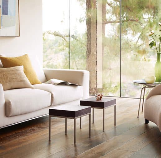 A living room with two couches and tables