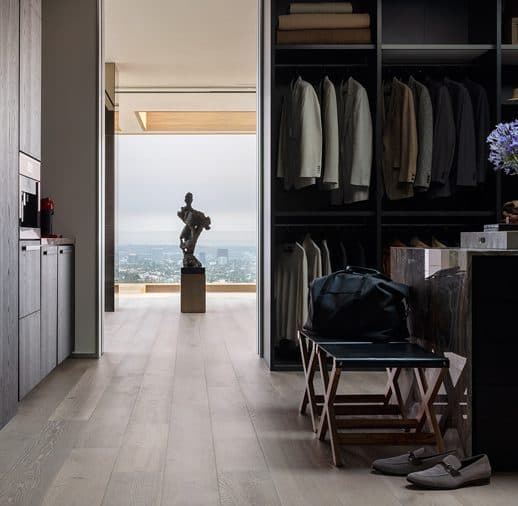 A room with a view of the ocean and a statue.