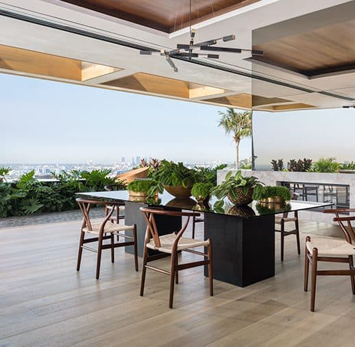 A restaurant with wooden chairs and tables in the middle of it.