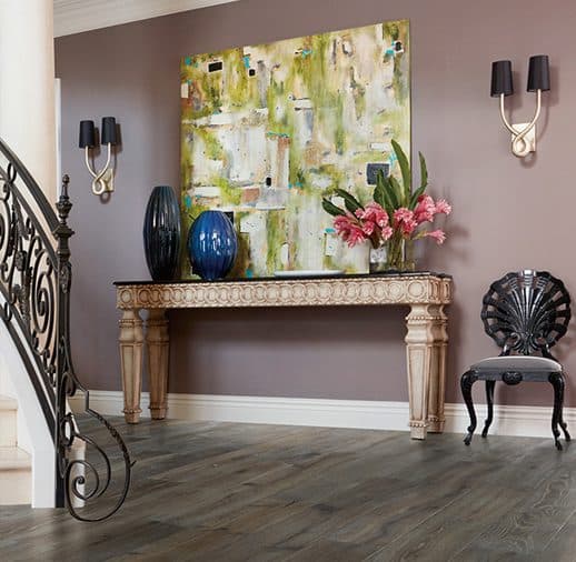 A foyer with a painting and a chair