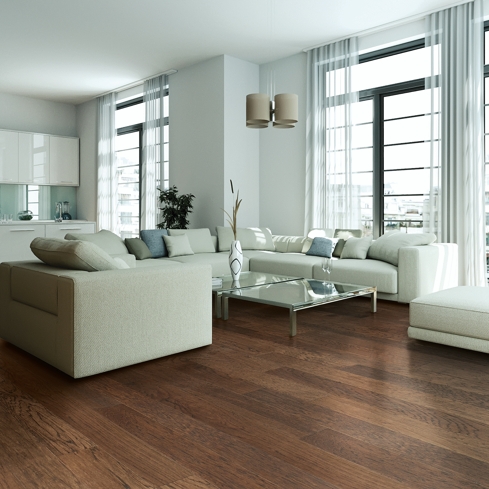 A living room with white furniture and large windows.