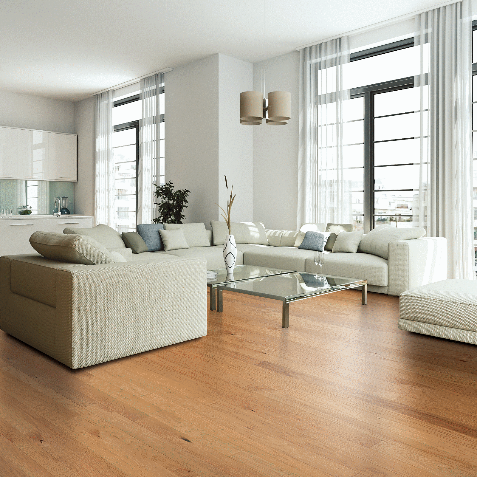 A living room with white furniture and large windows.