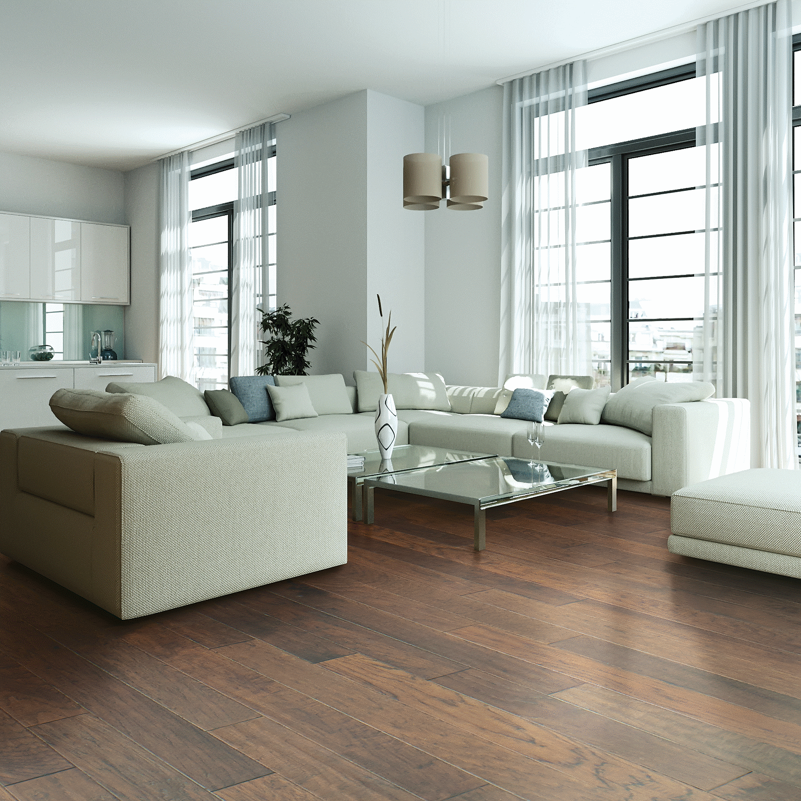 A living room with white furniture and large windows.