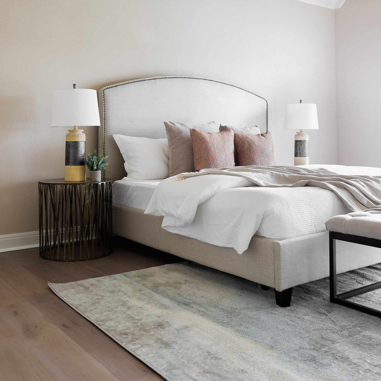 A bed room with a white bed and two lamps