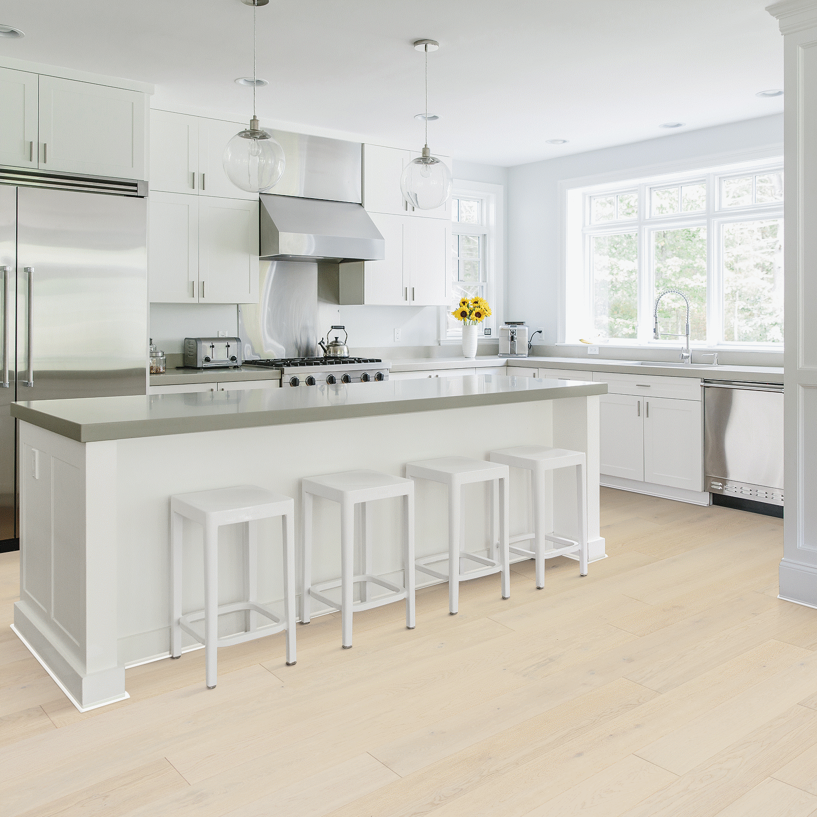 A kitchen with white cabinets and stainless steel appliances.