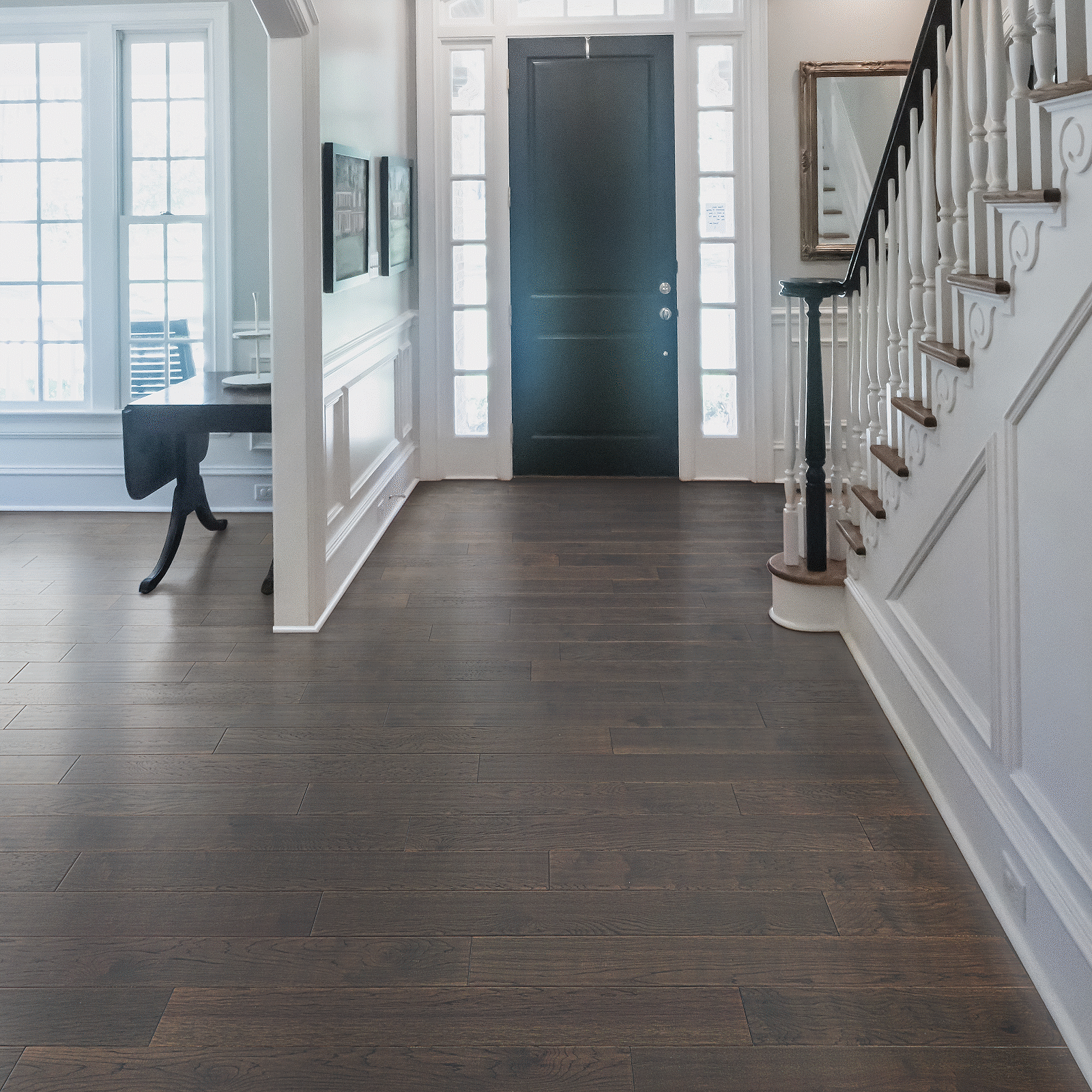 A hallway with stairs and a door.