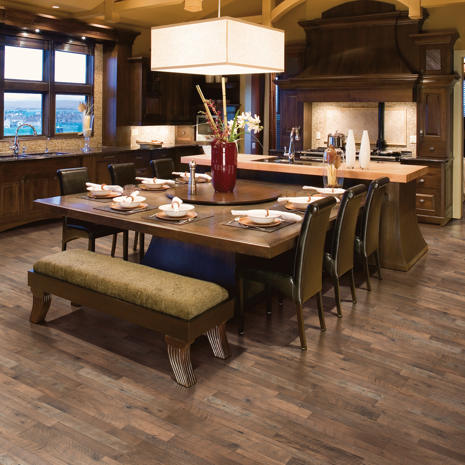 A dining room with wooden floors and a table.