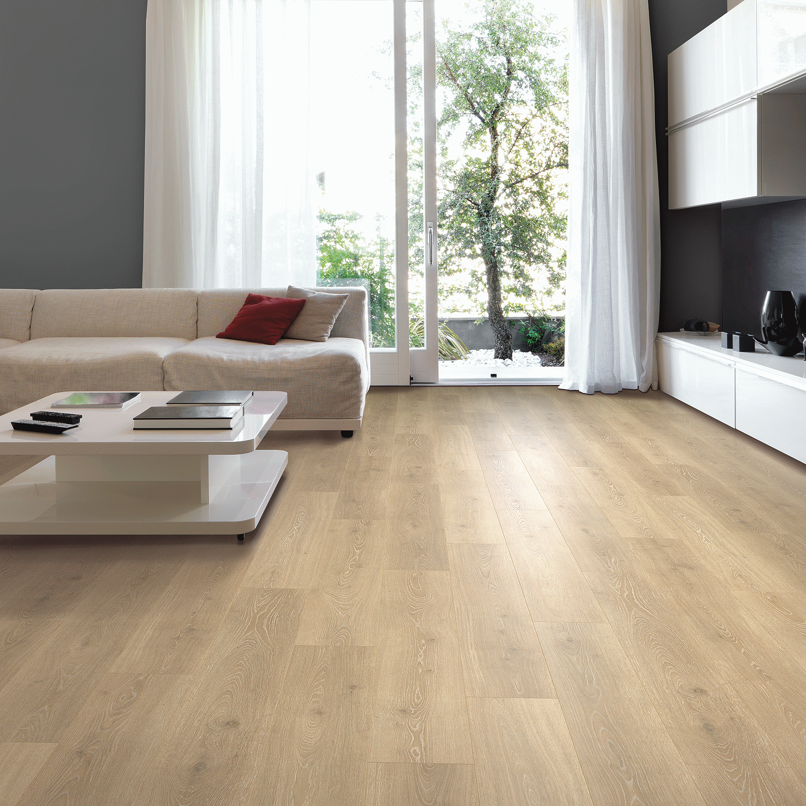 A living room with white furniture and sliding glass doors.