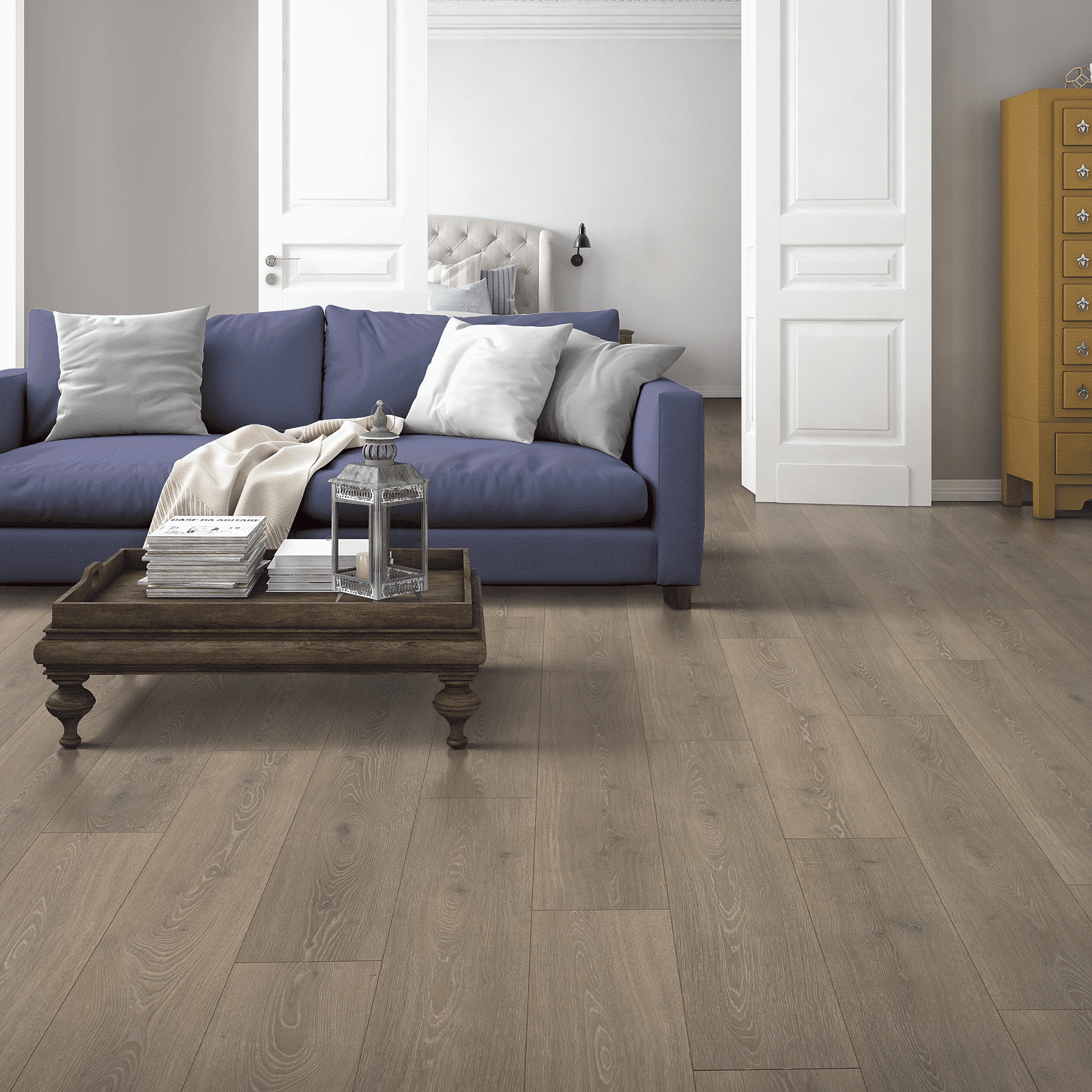 A living room with blue couch and white walls.