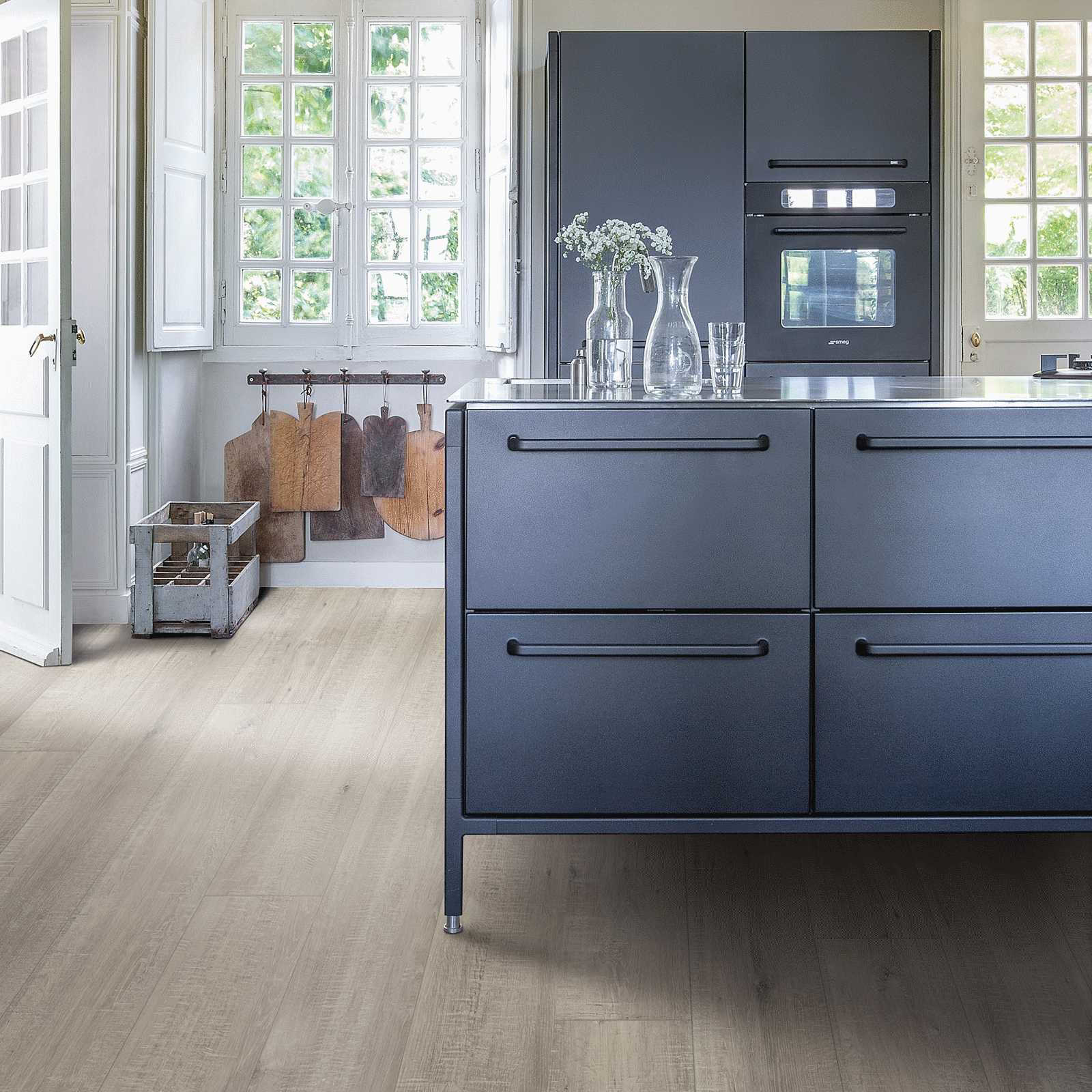A kitchen with blue cabinets and white counters.