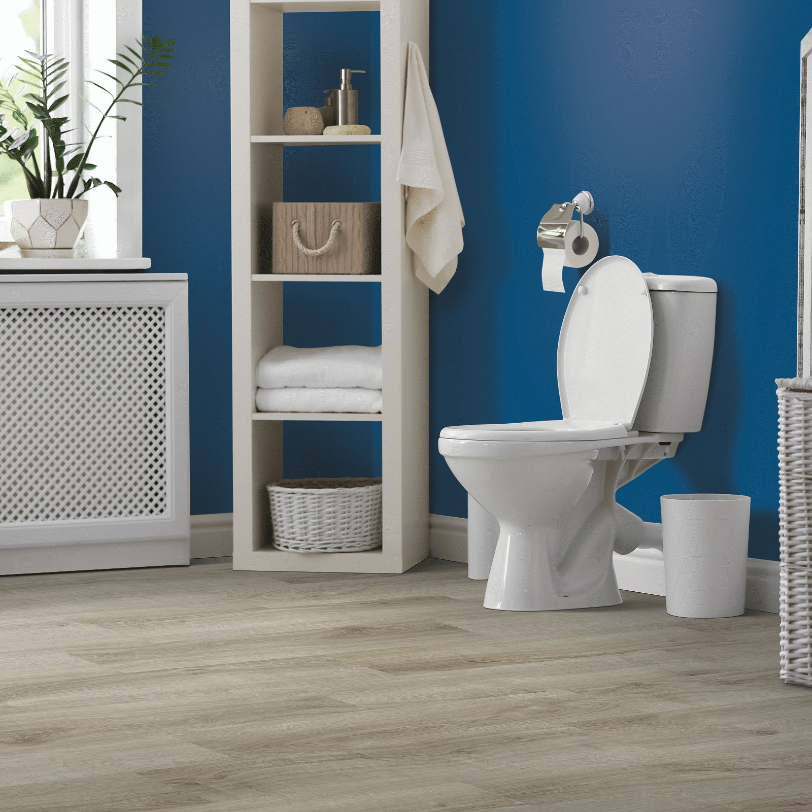 A bathroom with blue walls and white fixtures.