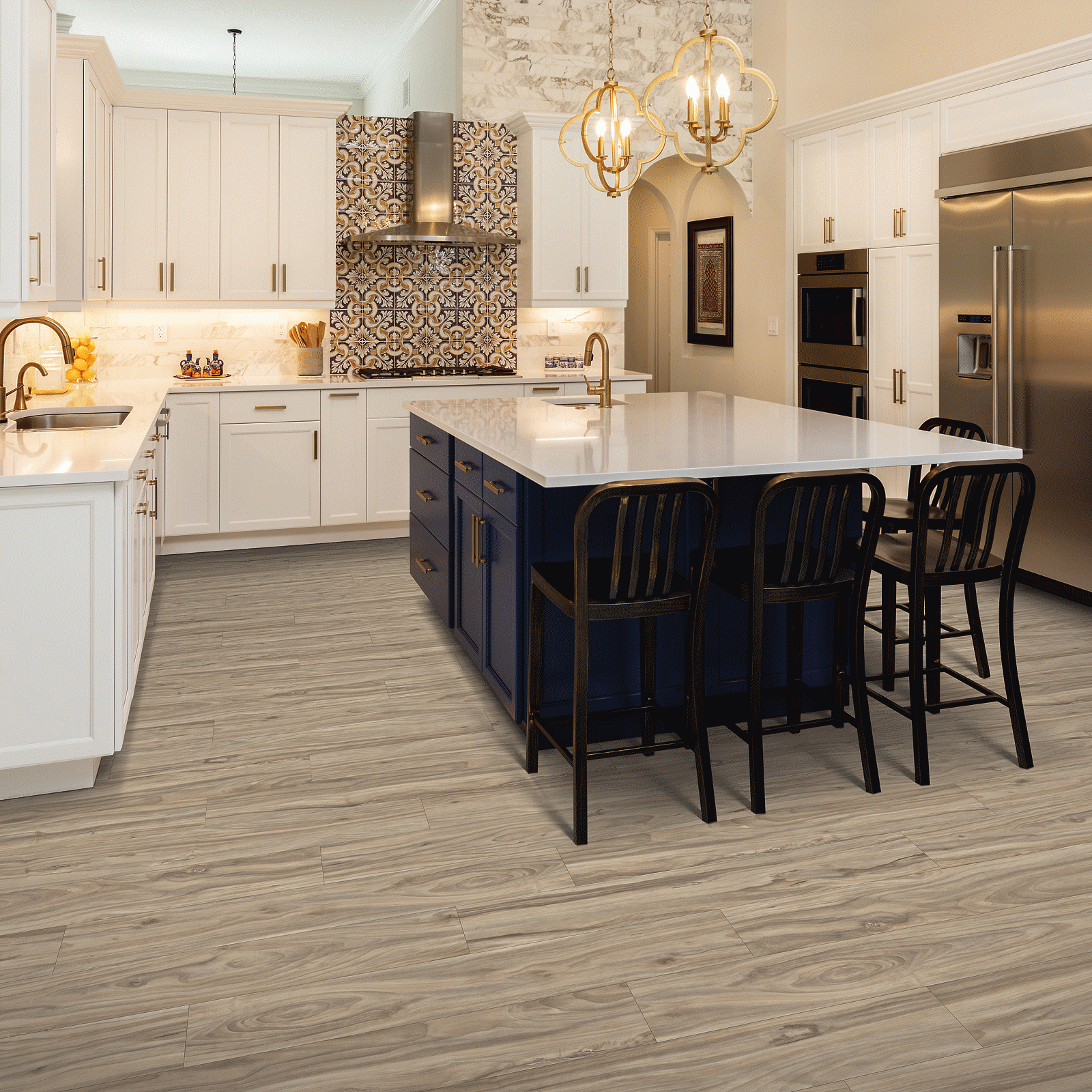 A kitchen with white cabinets and black island.