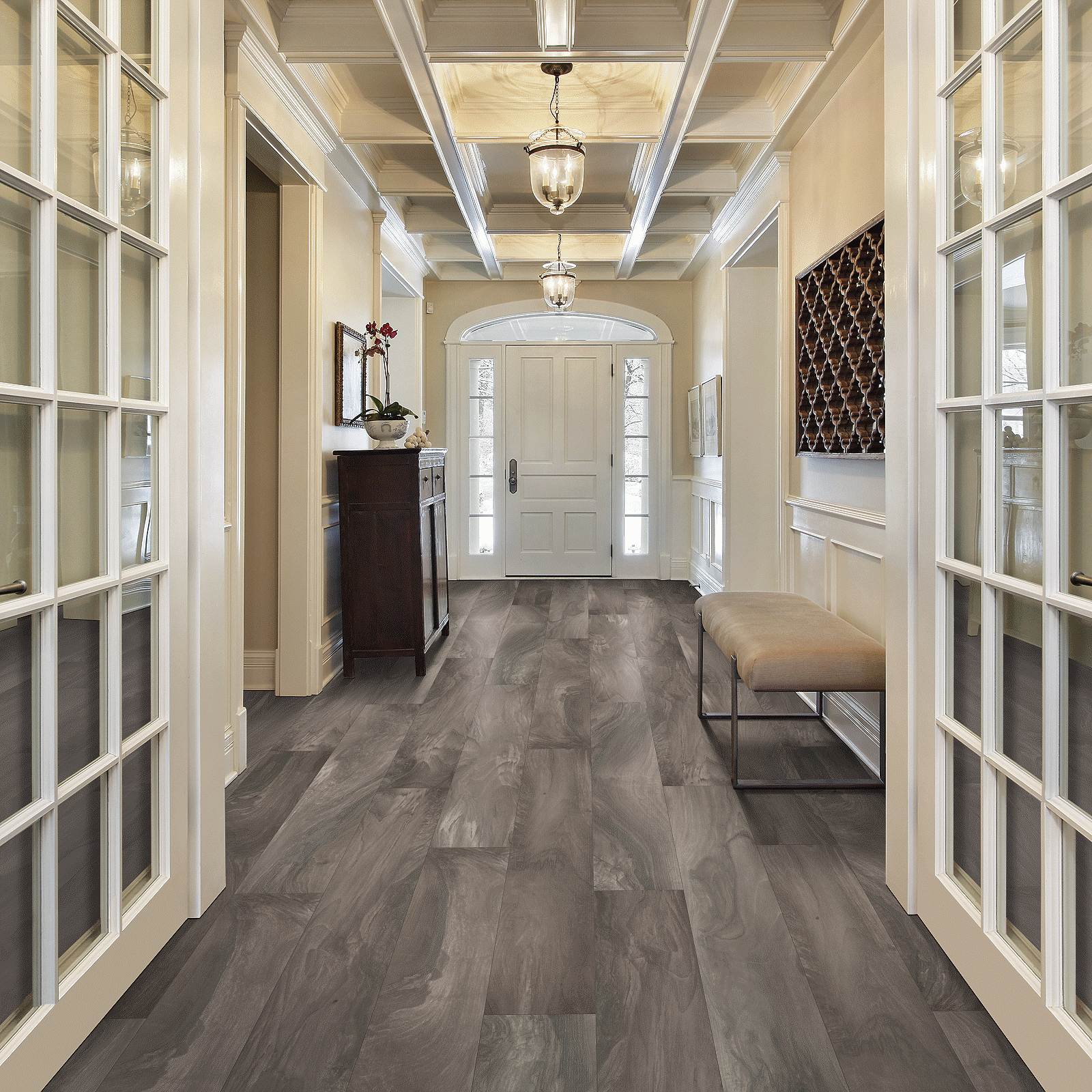 A hallway with two doors and a chair.