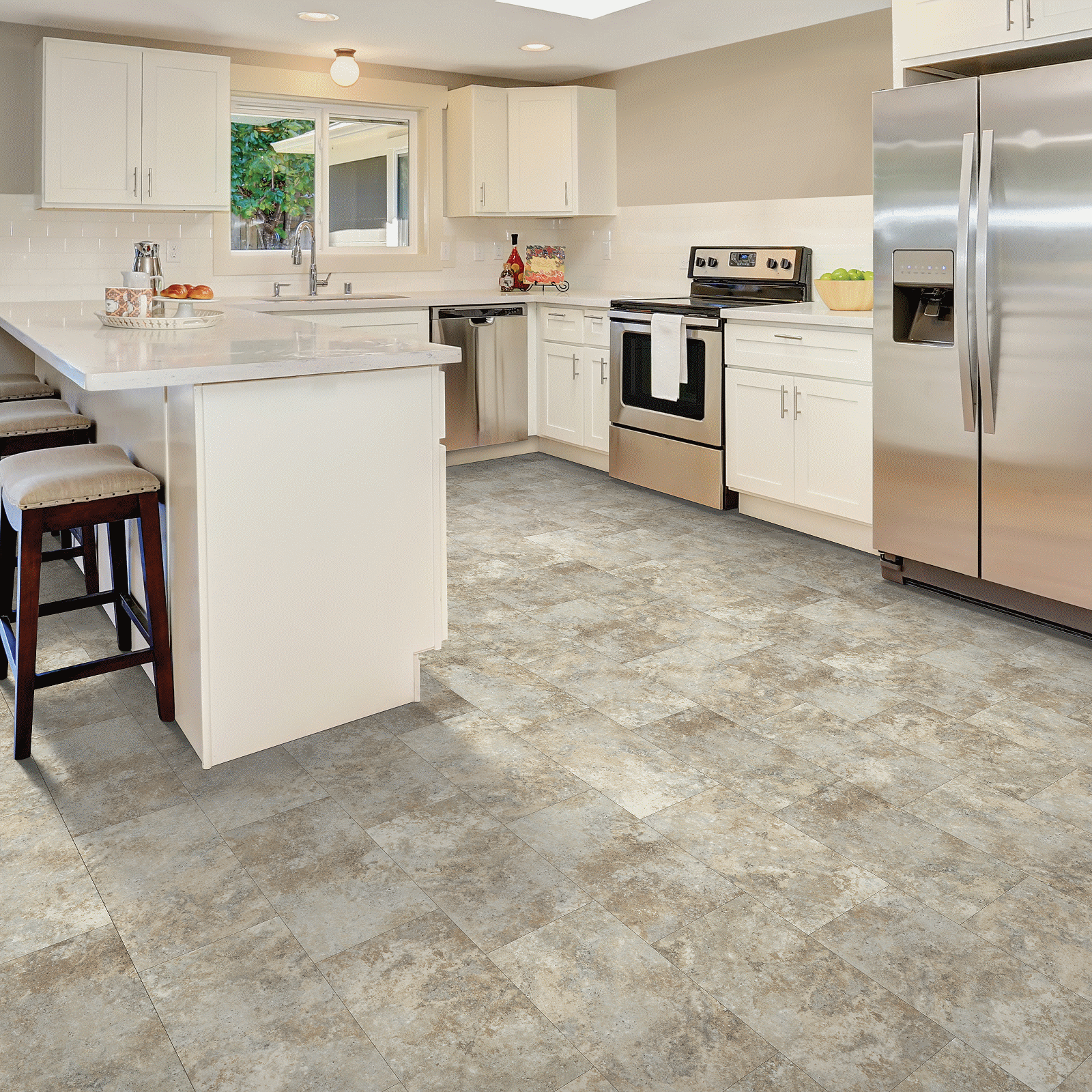 A kitchen with white cabinets and stainless steel appliances.