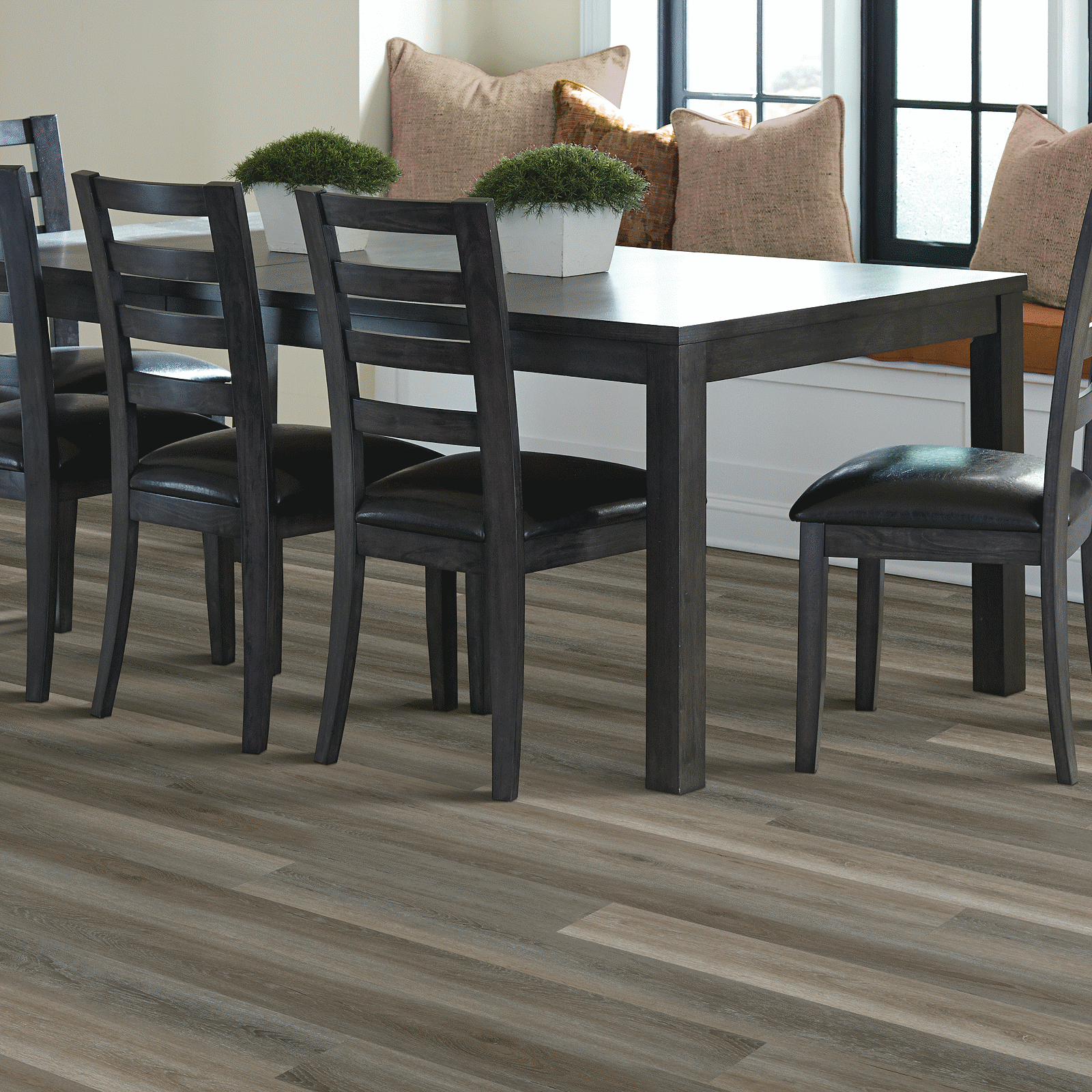 A dining room table with chairs and a bench.