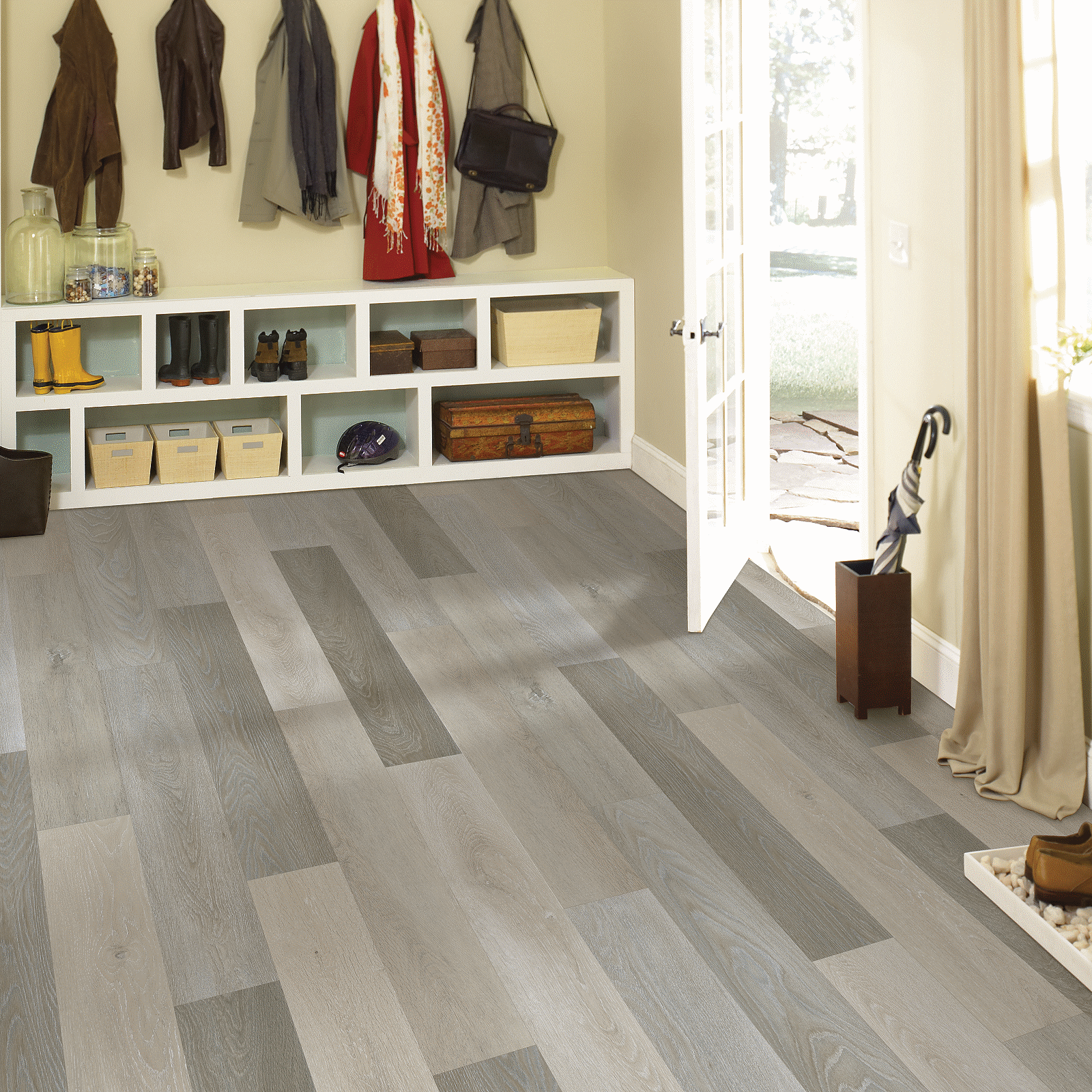 A room with many coats hanging on the wall.