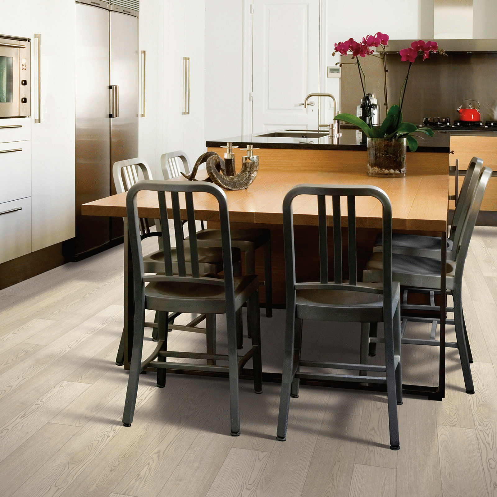 A kitchen with a table and chairs in it