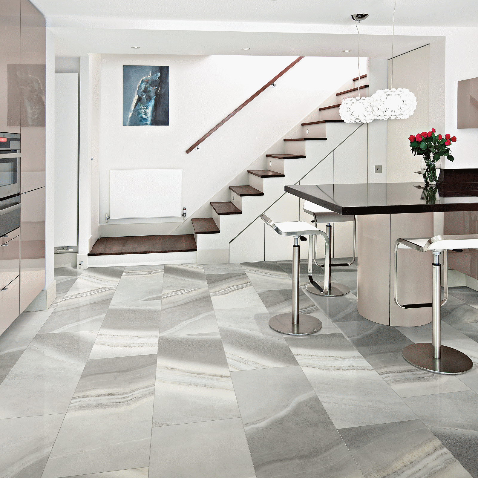 A kitchen with marble floors and stairs