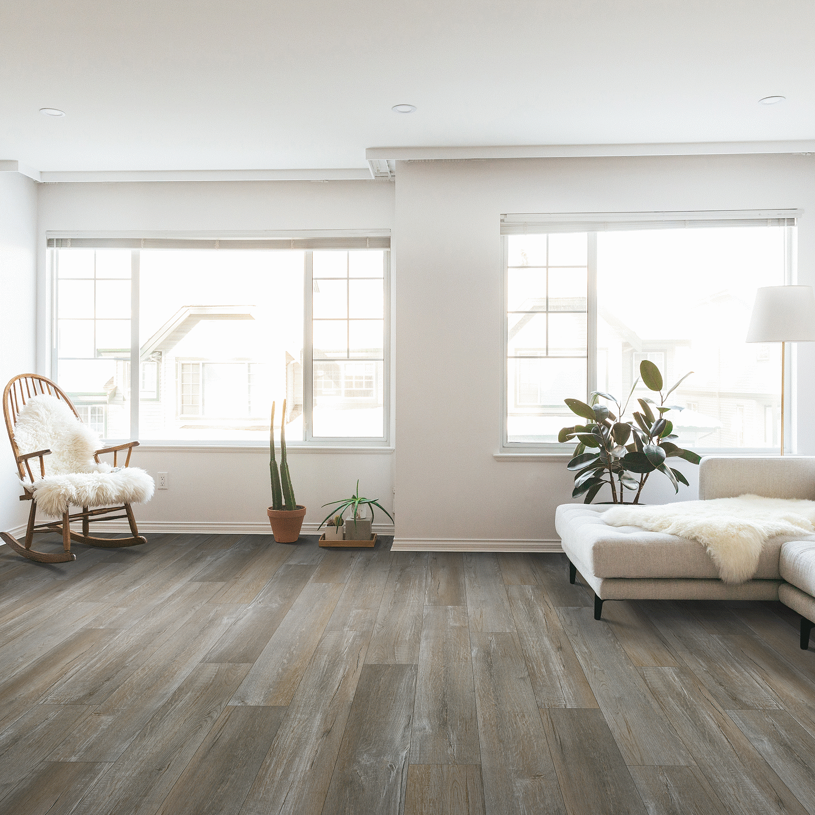 A living room with white walls and wooden floors.