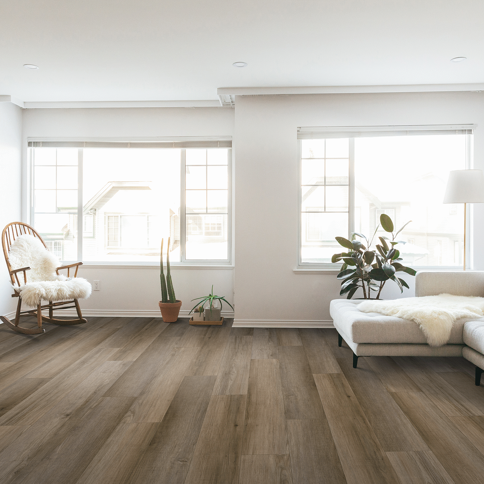 A living room with hard wood floors and white walls.