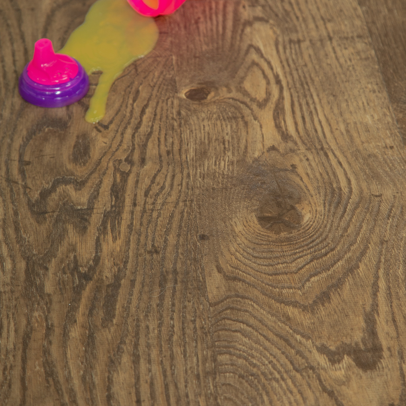 A wooden floor with some pink and yellow objects on it