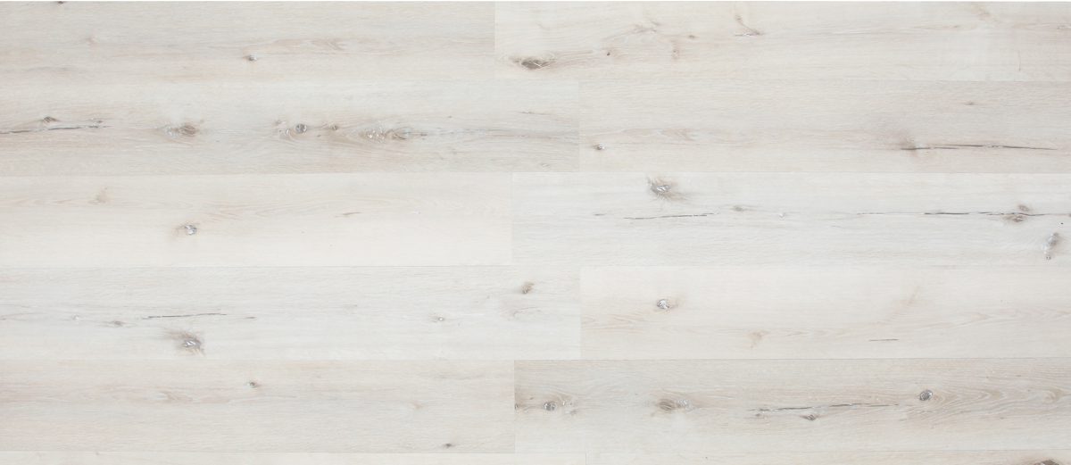 A white wood floor with some small pieces of wood