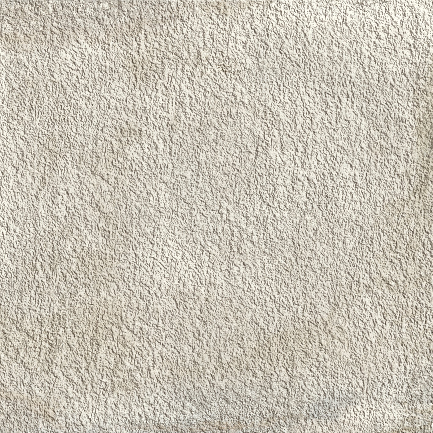 A close up of the fabric surface of a white carpet.