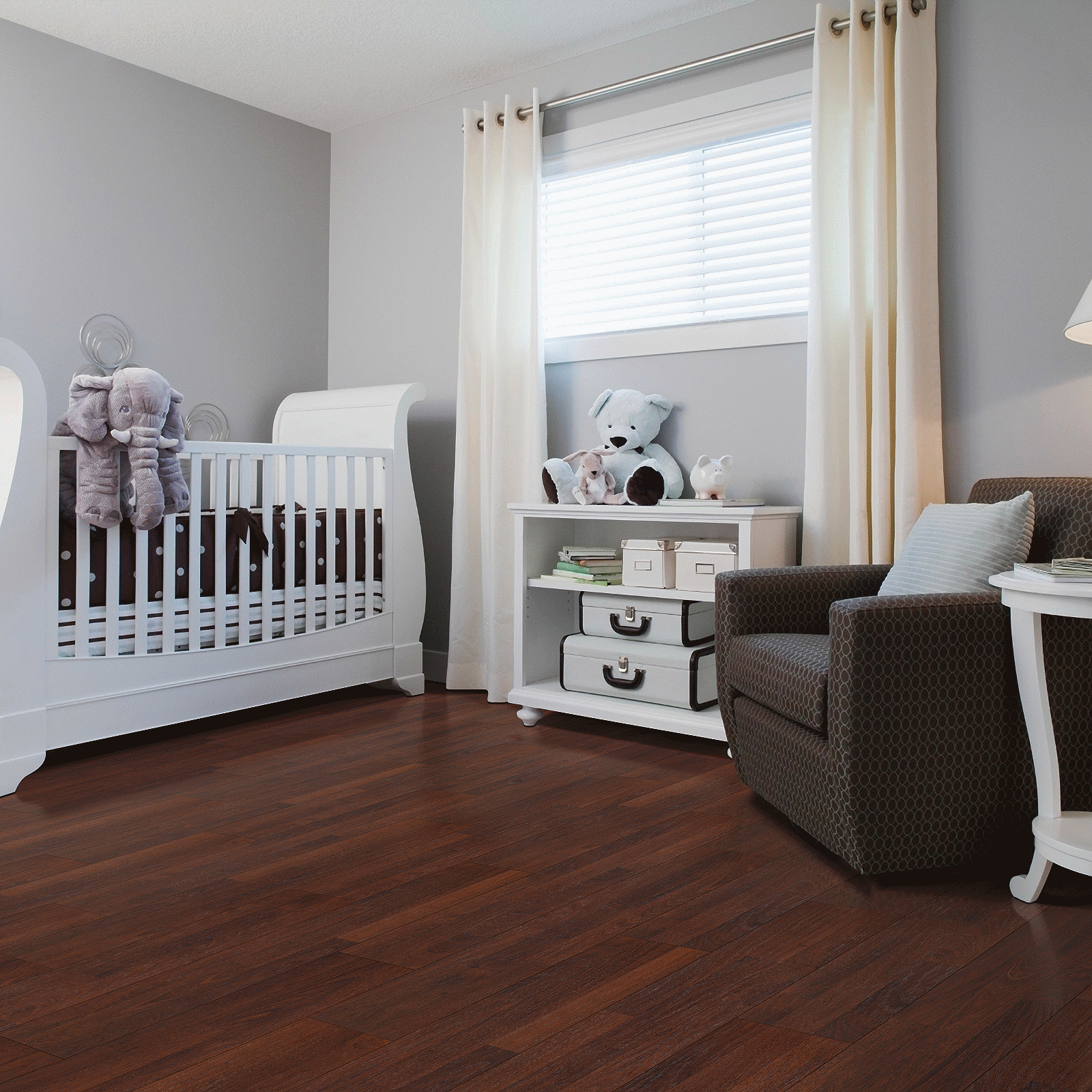 A baby room with a crib, chair and table.