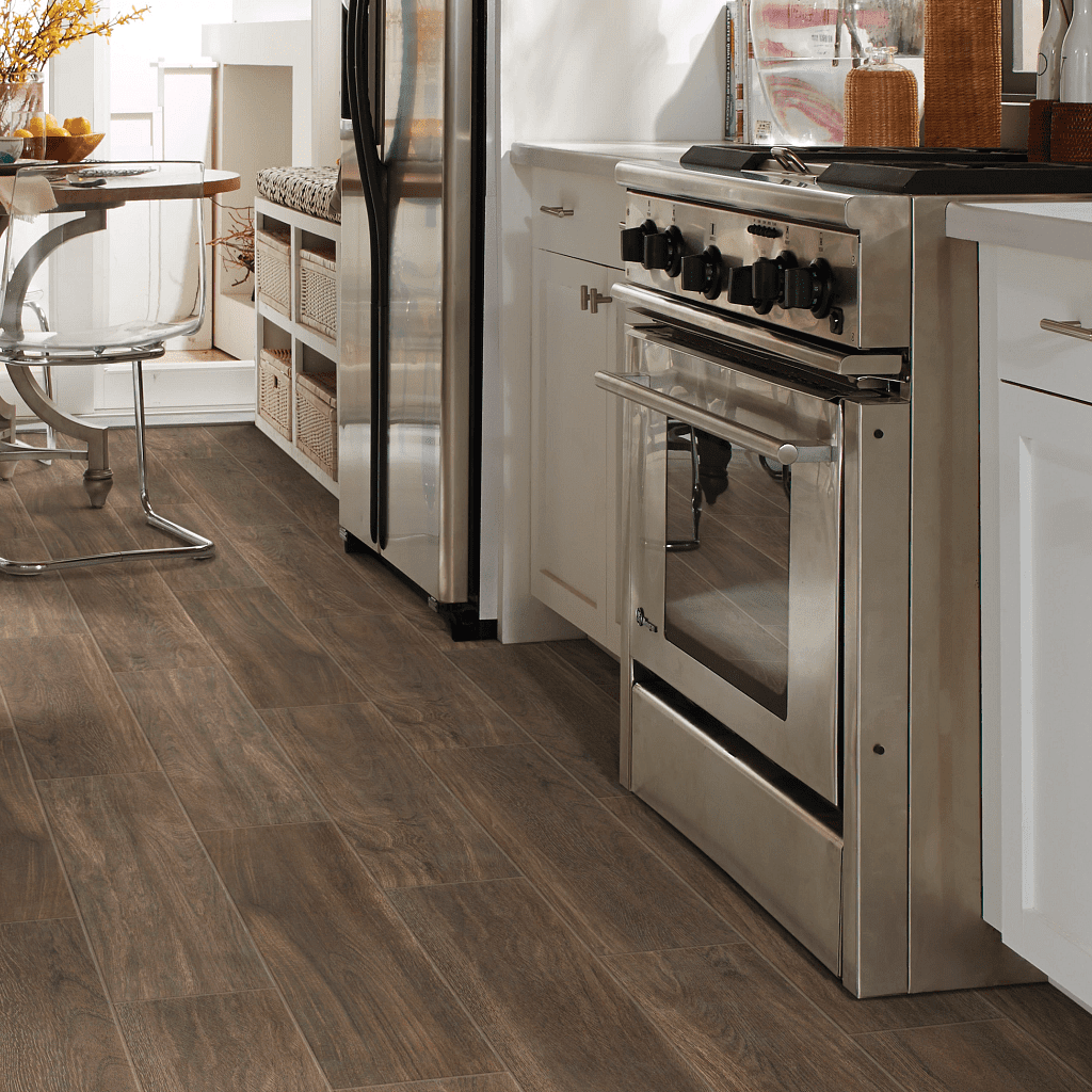 A kitchen with wooden floors and white cabinets.
