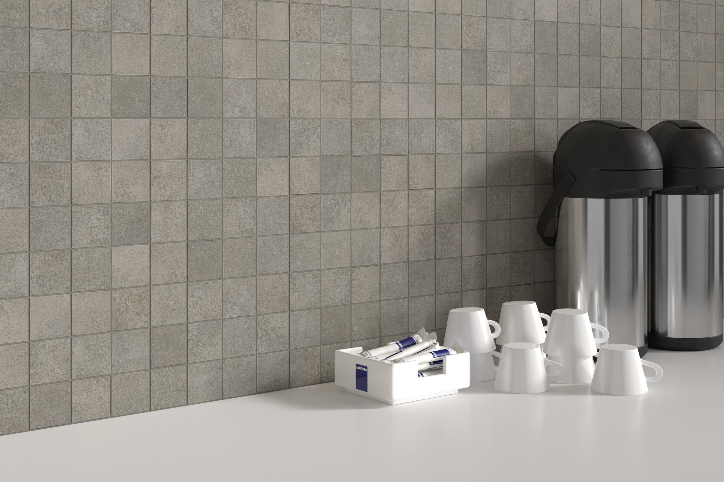 A counter with cups and coffee pots on it.