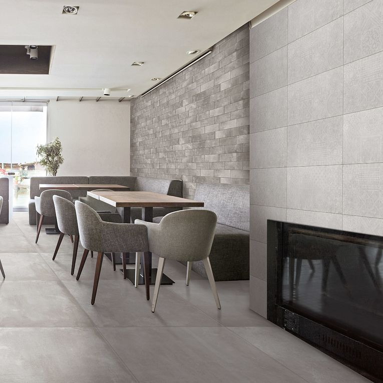 A room with a fireplace and chairs in it