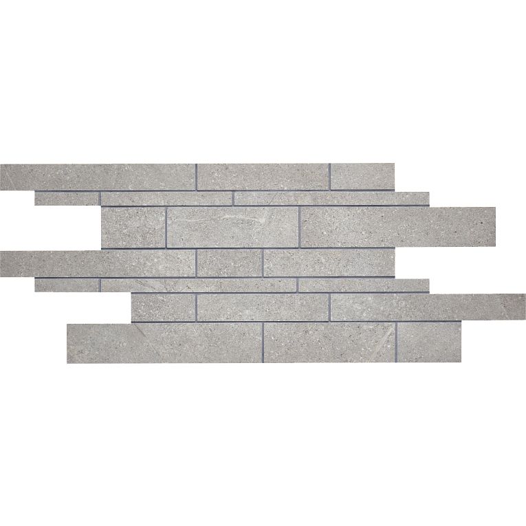 A gray brick wall with a strip of white bricks on it.