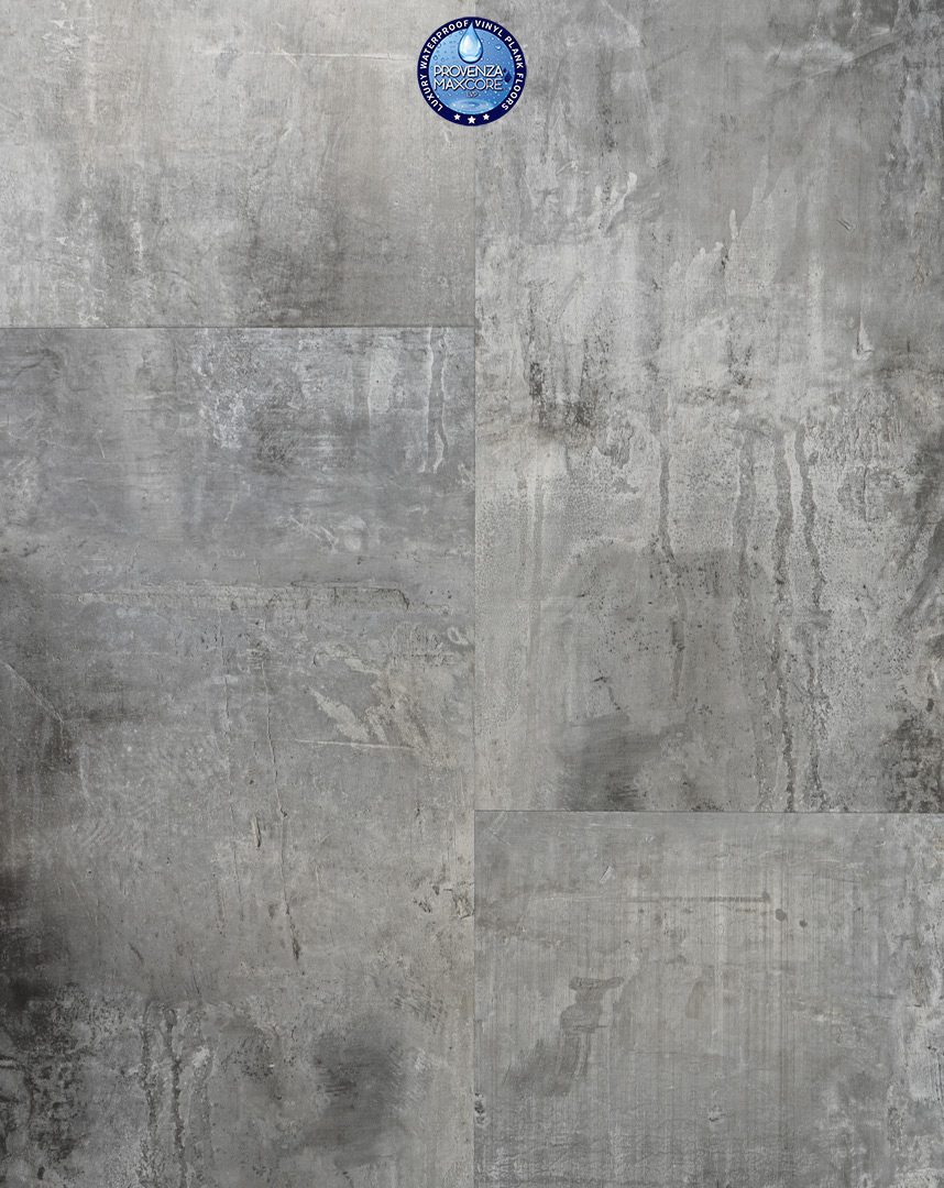 A gray concrete wall with some black spots on it