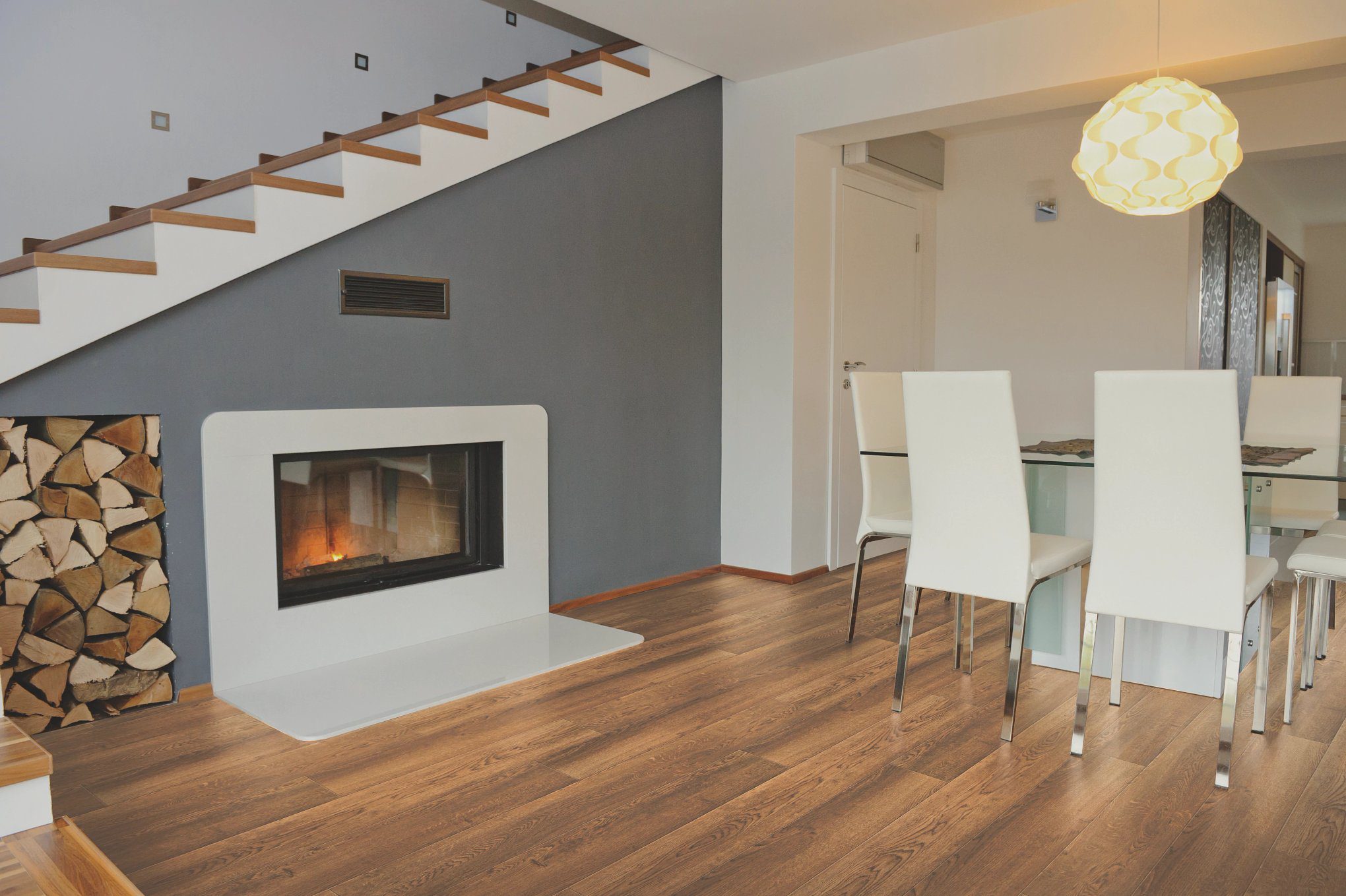 A room with a fireplace and wooden floors