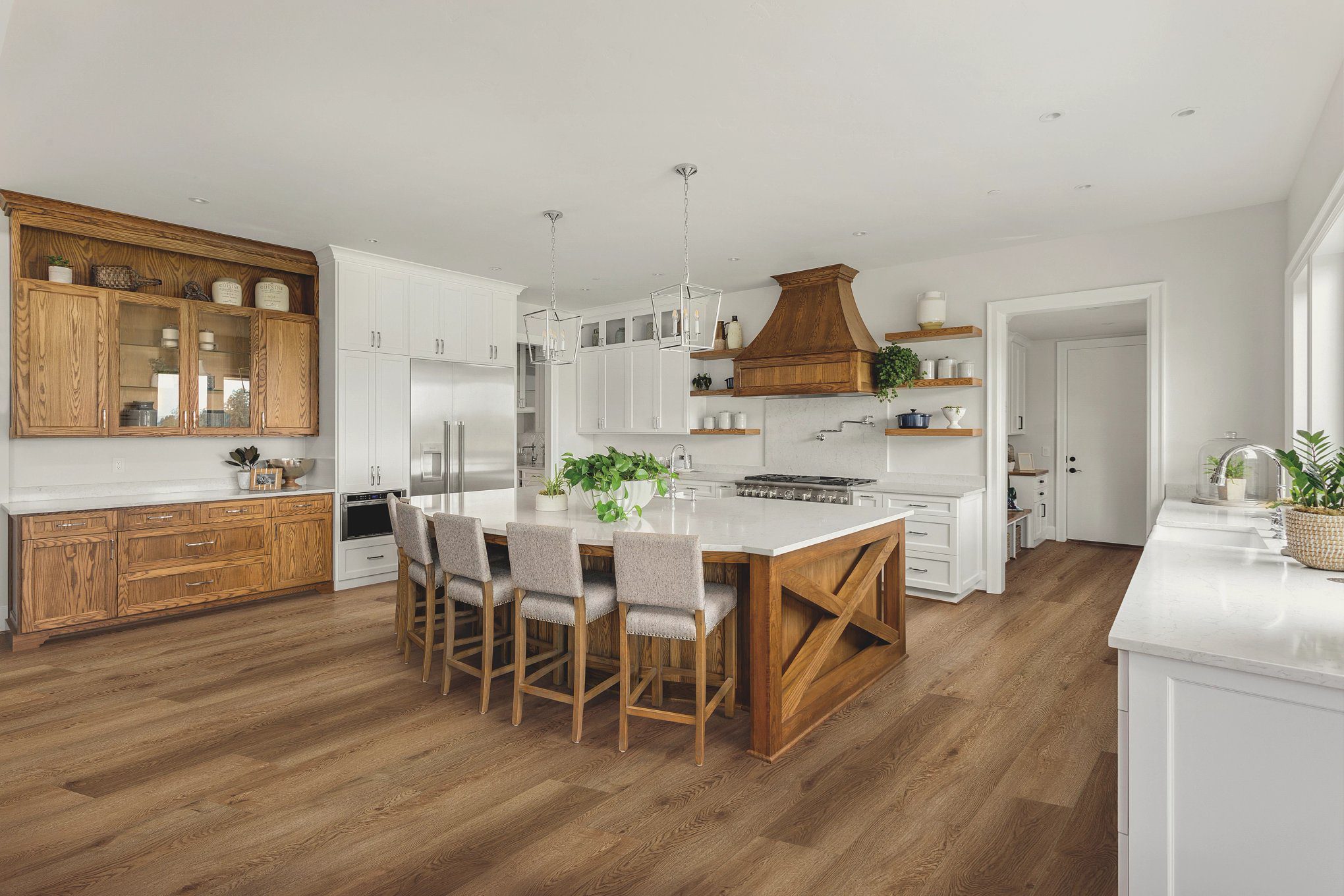 A kitchen with wooden floors and white walls.