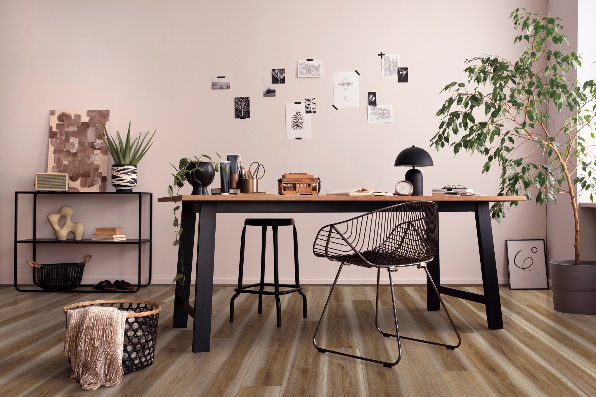 A room with a table and chairs, plants on the wall.