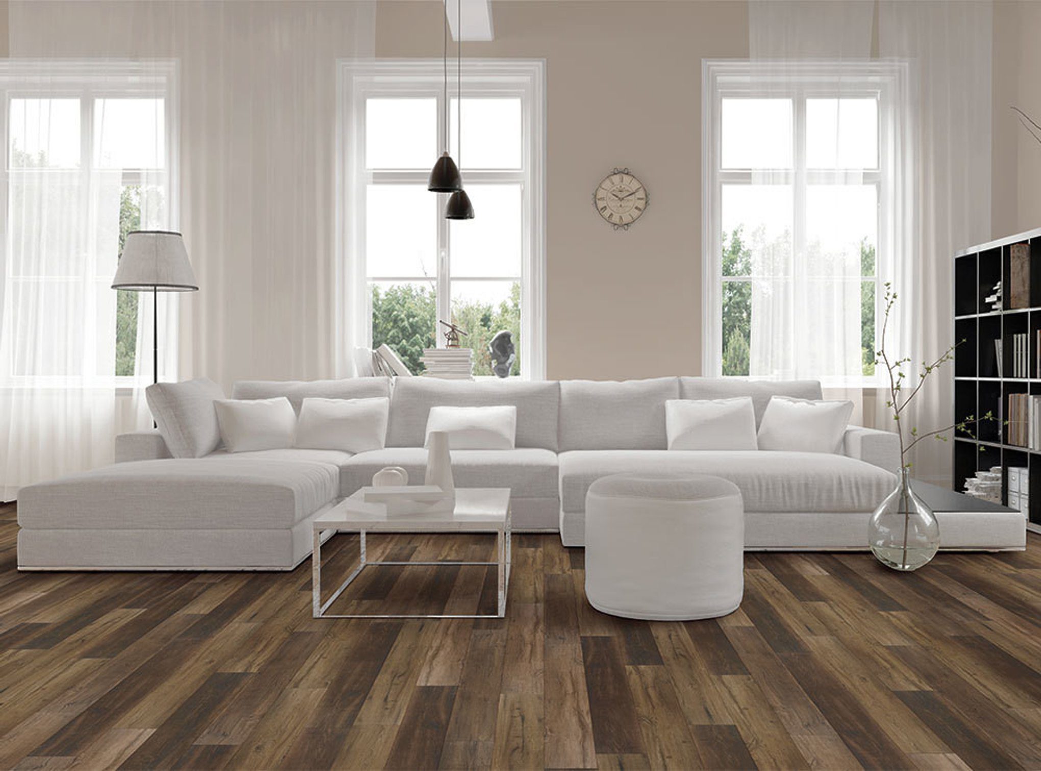 A living room with white furniture and wood floors.