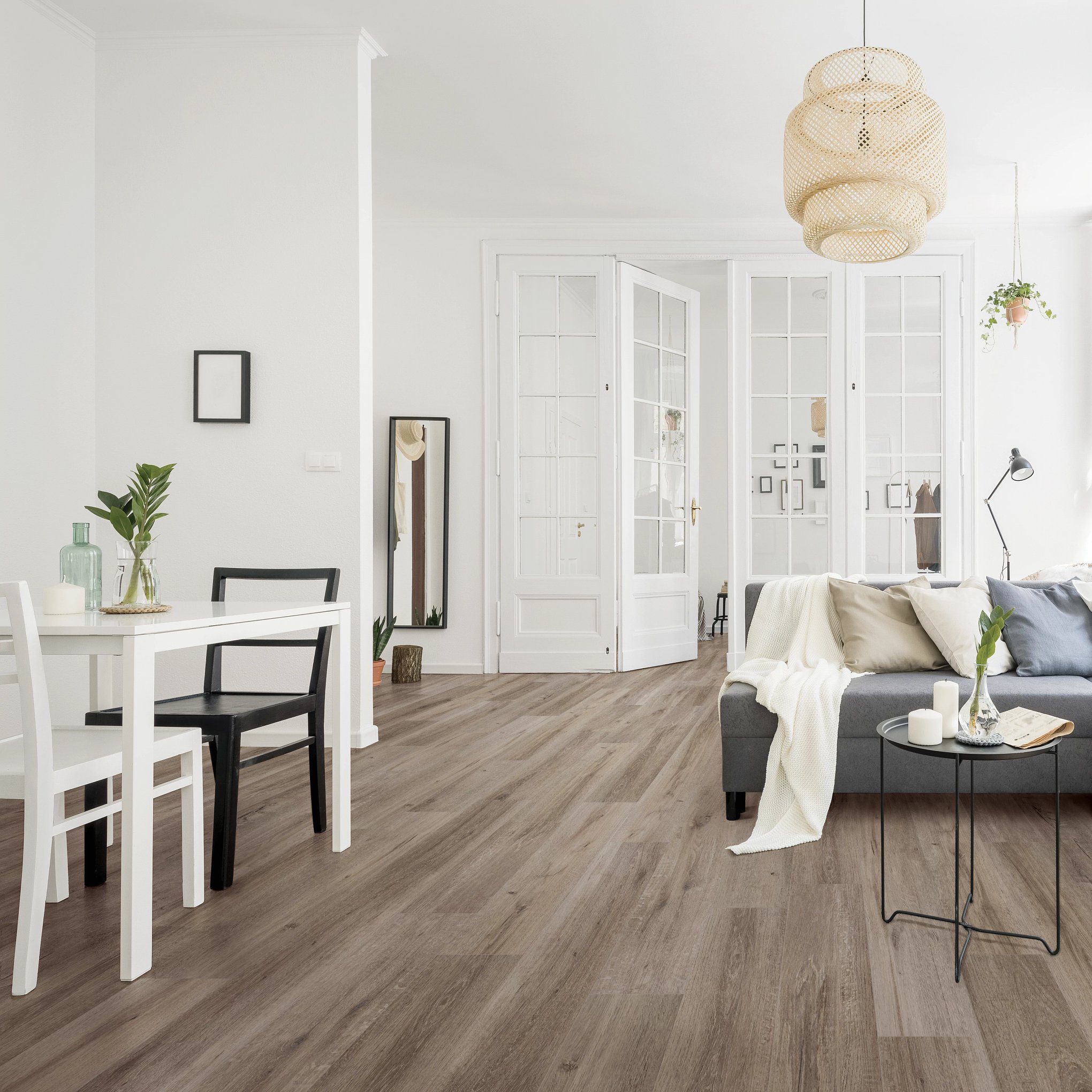 A living room with white walls and wooden floors.