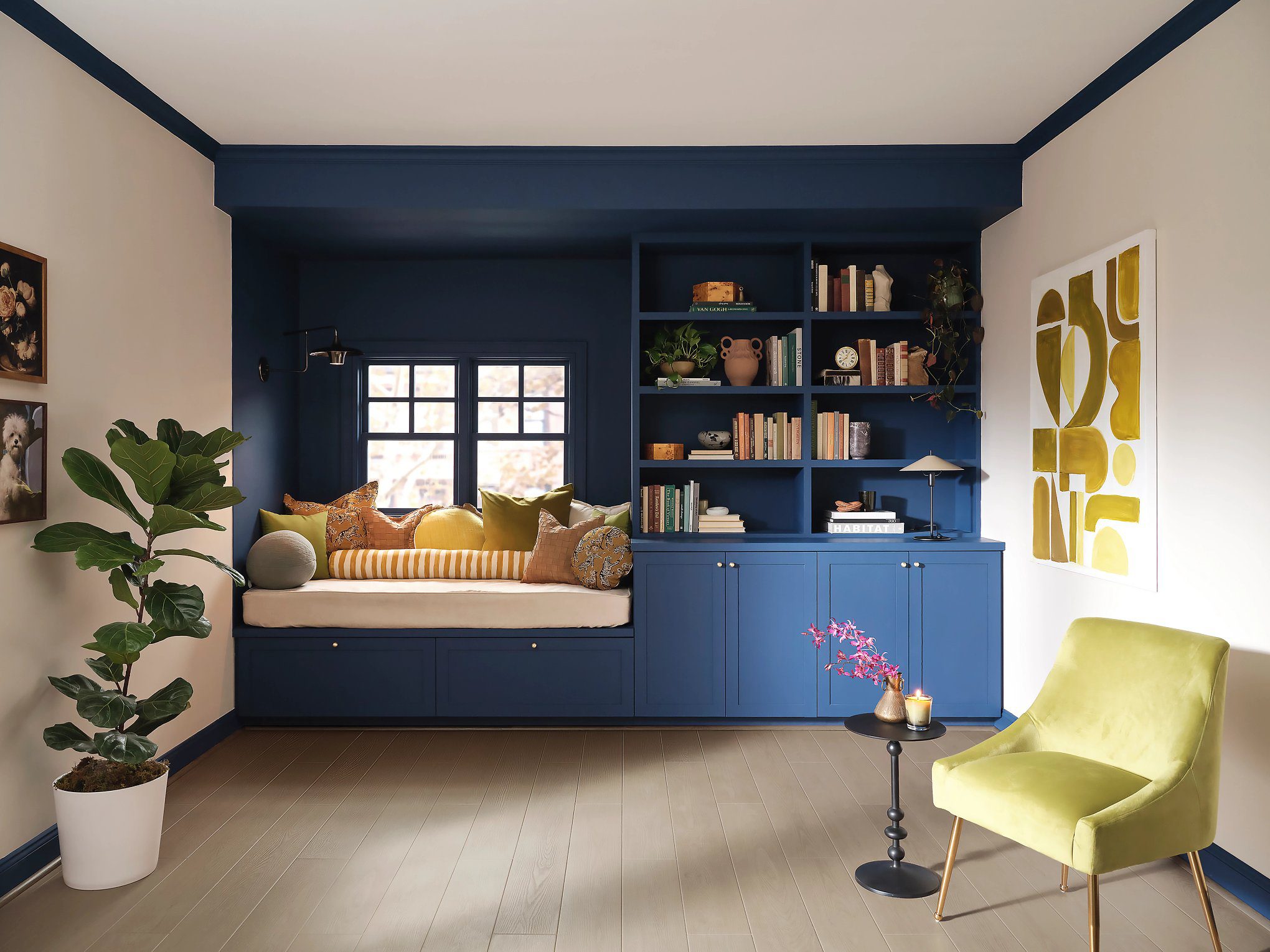 A living room with blue walls and yellow accents.