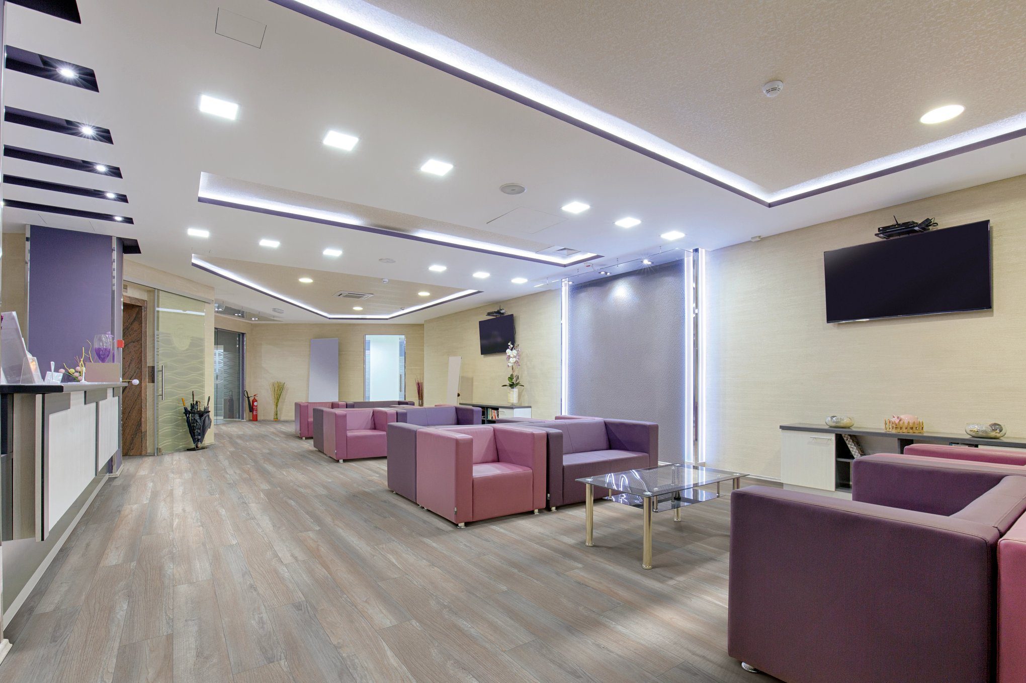 A room with many couches and tables in it