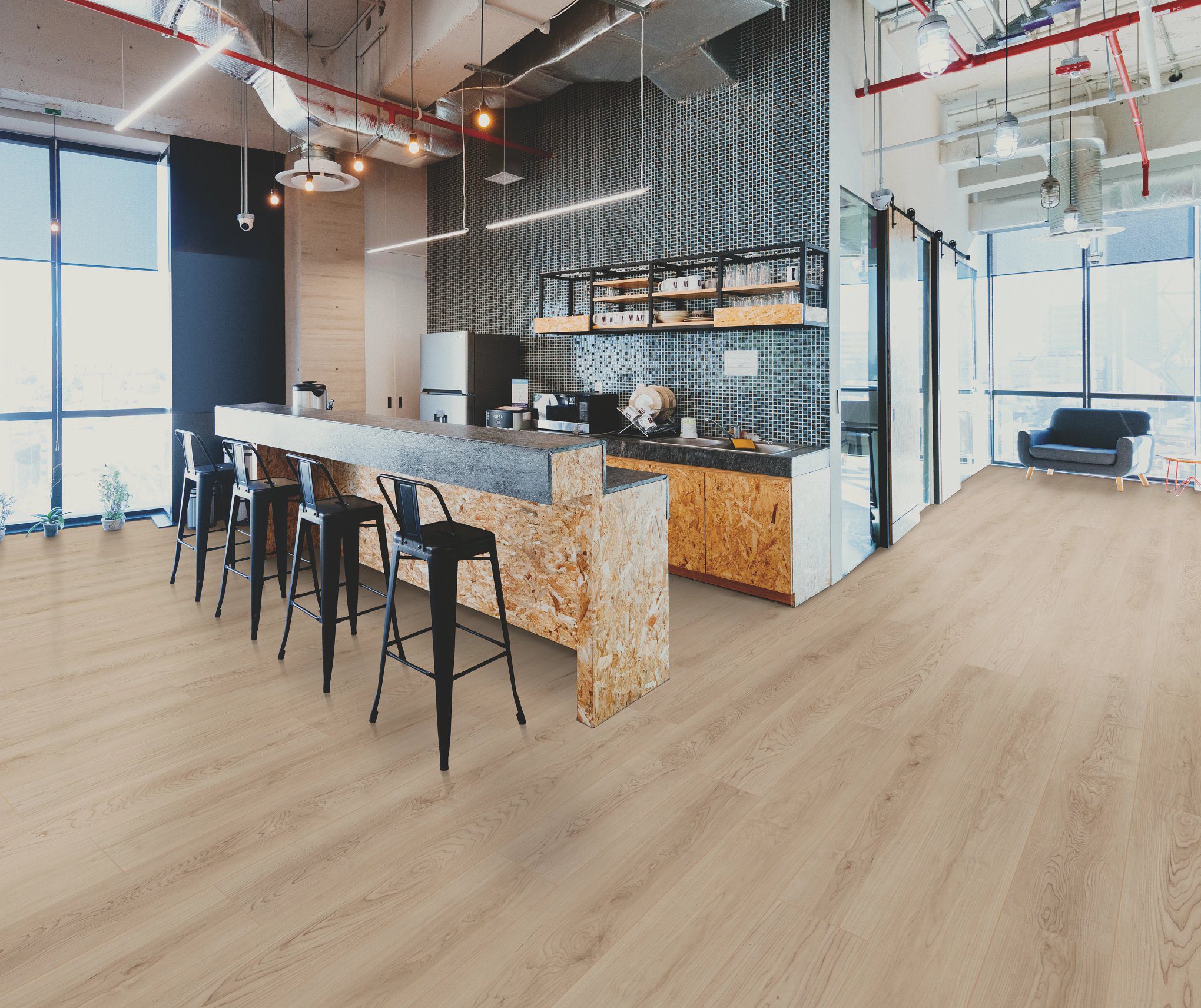 A room with wooden floors and black chairs.