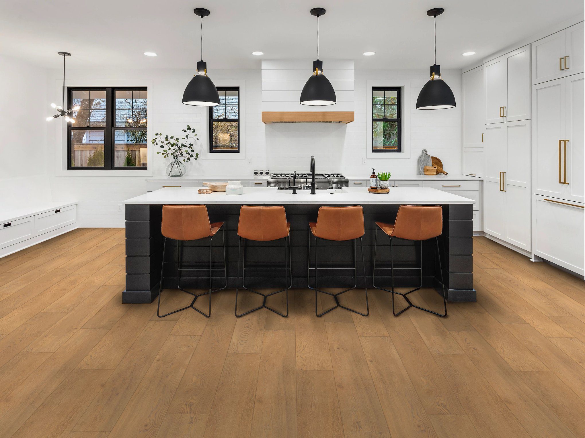 A kitchen with an island and black chairs