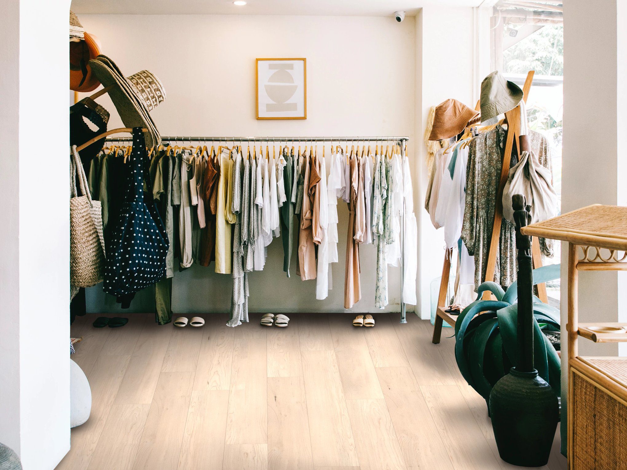 A room filled with lots of clothes hanging on racks.